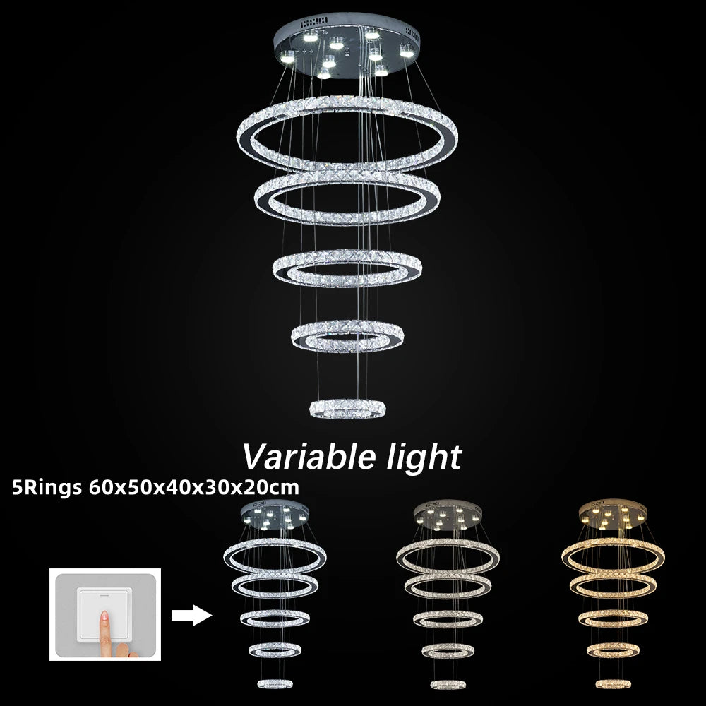 Chandelier with five spiral rings on a black background, showing variable light settings.