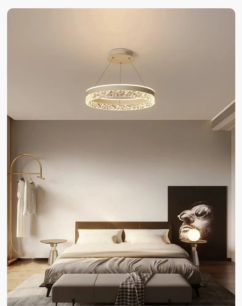 Modern bedroom with a ceiling light fixture, bed, and wall art.