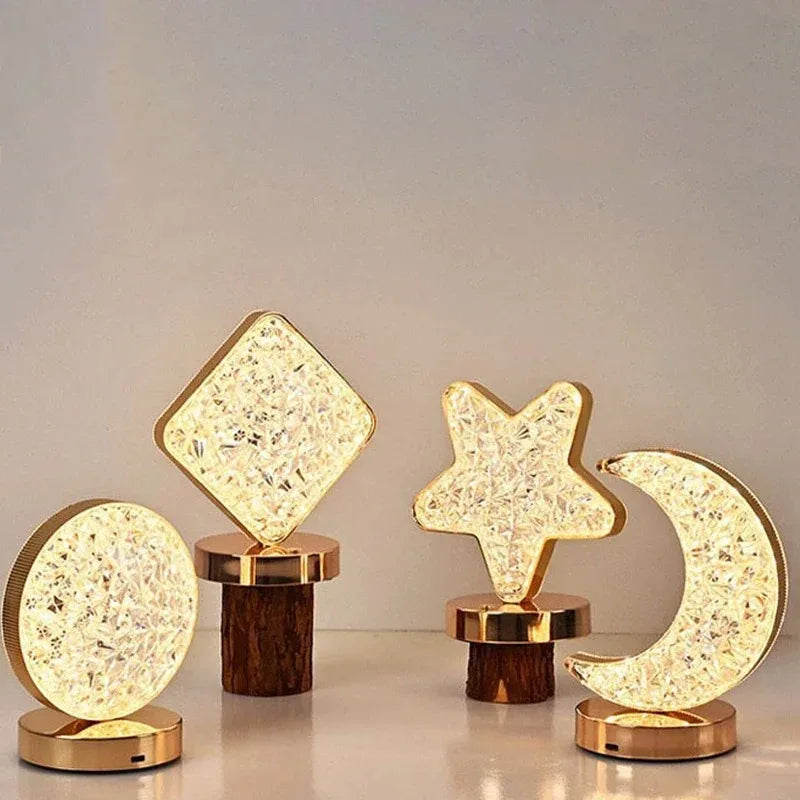Set of decorative lamps shaped like a square, star, and crescent moon on wooden bases.