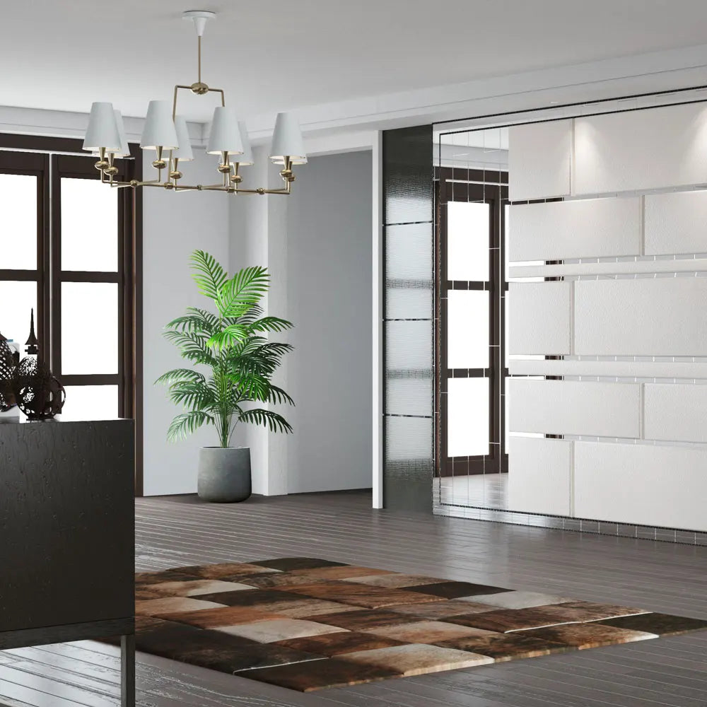 Modern interior with a checkered rug, plant, and chandelier.
