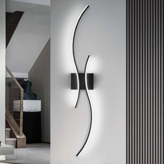 Modern wall light fixture on a gray wall with a staircase in the background